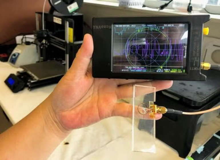 Researchers at the University of Waterloo developed a palm-sized device, costing about $70 to produce, that uses a gold-plated sensor and vector network analyzer to rapidly identify E. coli contamination in water.
