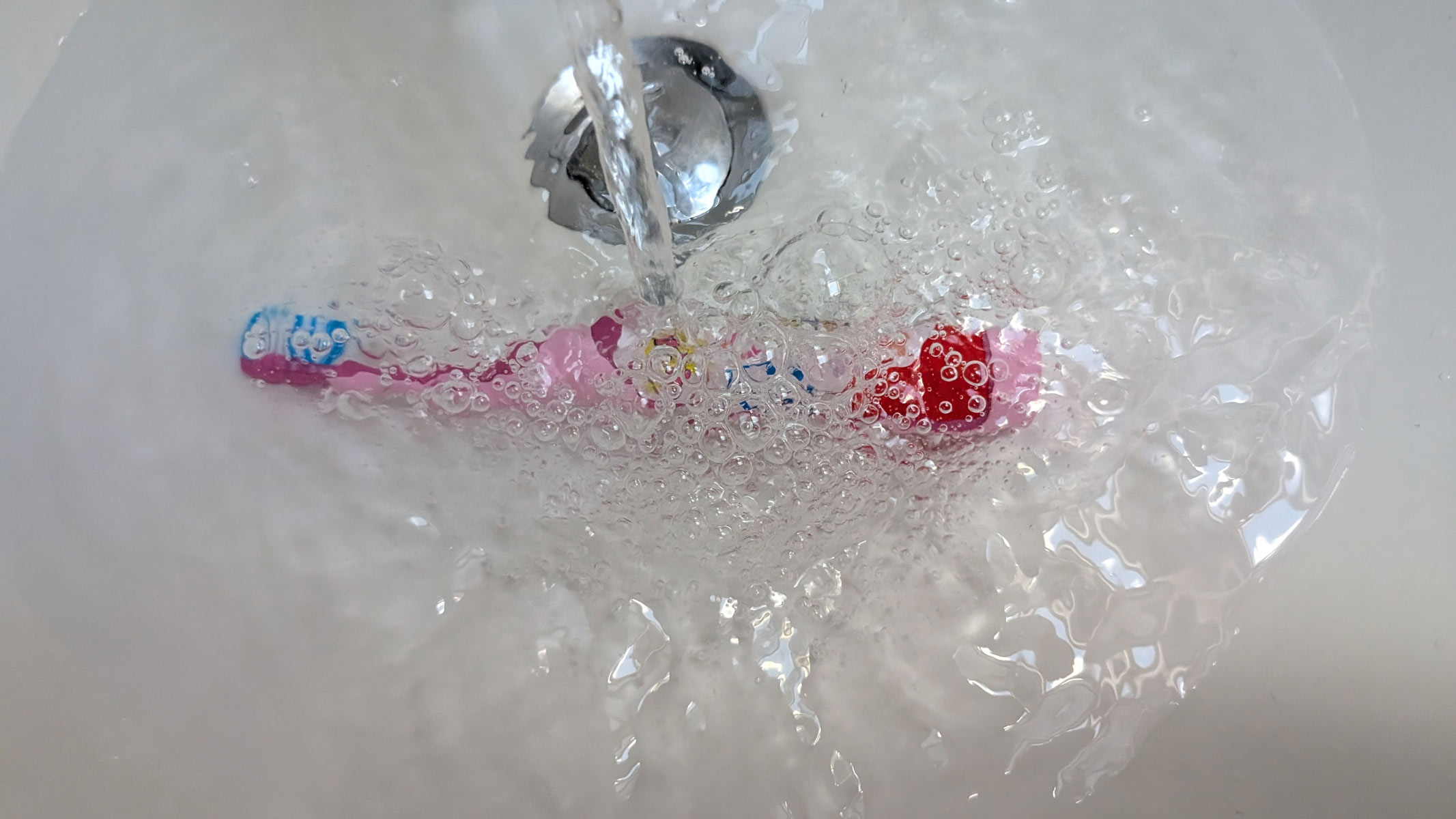 Colgate Kids Battery Powered Toothbrush being submerged underwater by our reviewer