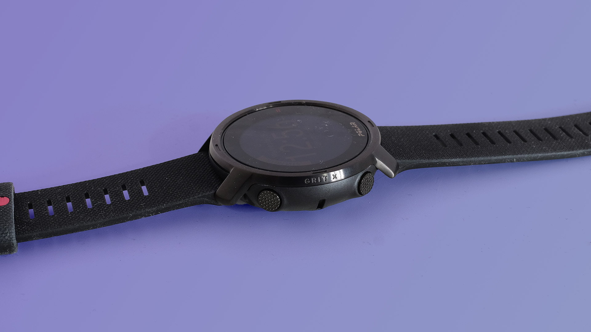 The Polar Grit X on a purple background, showing the side view.
